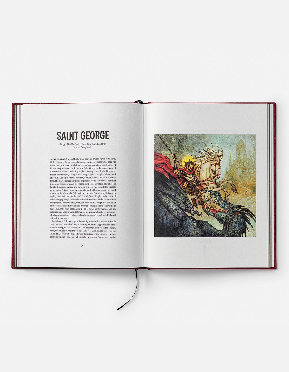 Open Dragons book at the Saint George chapter, showing a knight on a rearing white horse fighting a dragon.
