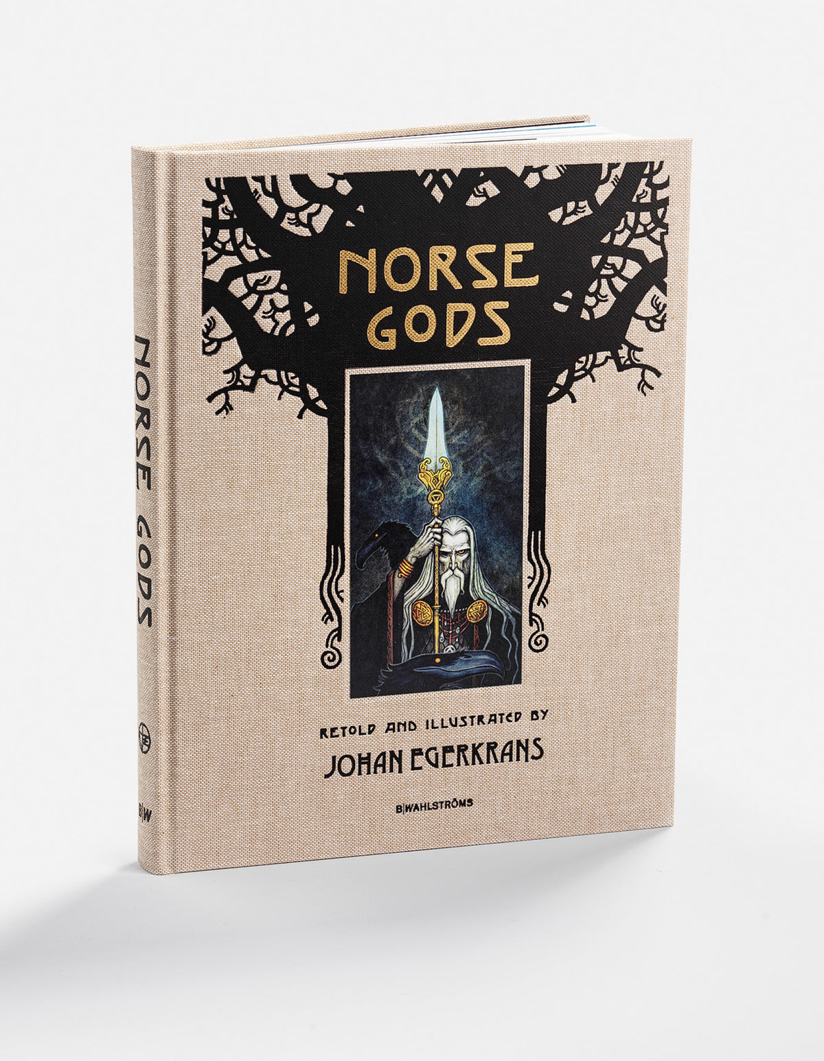 Norse Gods hardcover in beige cloth, showing Odin holding a spear beneath black World Tree branches.