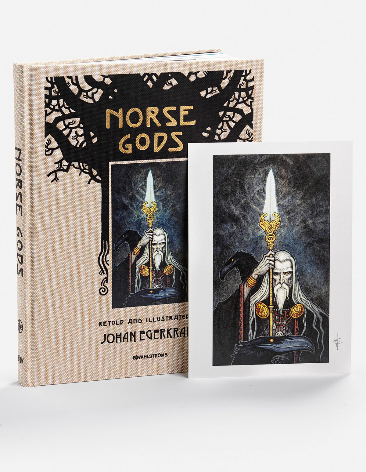 Norse Gods hardcover beside a signed art print of white-bearded Odin holding a spear, with a raven at his side.